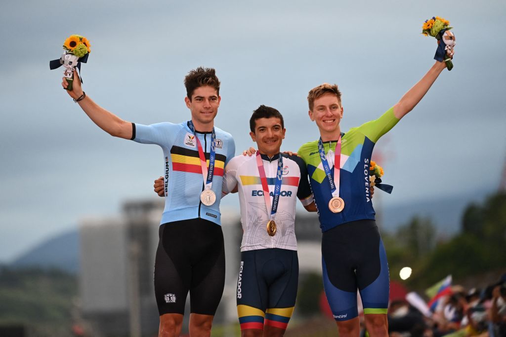 LR Silver medallist Belgiums Wout van Aert Gold medallist Ecuadors Richard Carapaz and bronze medallist Slovenias Tadej Pogacar celebrate on the podium during the medal ceremony for the mens cycling road race of the Tokyo 2020 Olympic Games at the Fuji International Speedway in Oyama Japan on July 24 2021 Photo by Greg Baker AFP Photo by GREG BAKERAFP via Getty Images