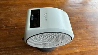 BenQ GV31 home cinema projector on wooden table orientated for ceiling viewing