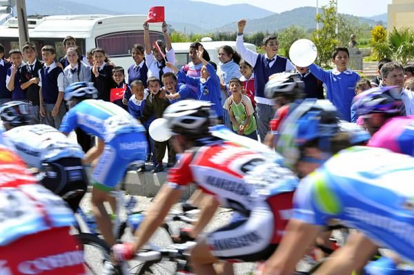 Children cheer on the peloton during stage 2.