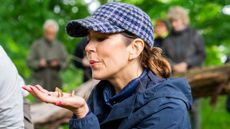 Queen Mary of Denmark releases butterflies in the forest as the Queen visits the WWF Nature Project at Knudshoved Odde on May 27, 2025
