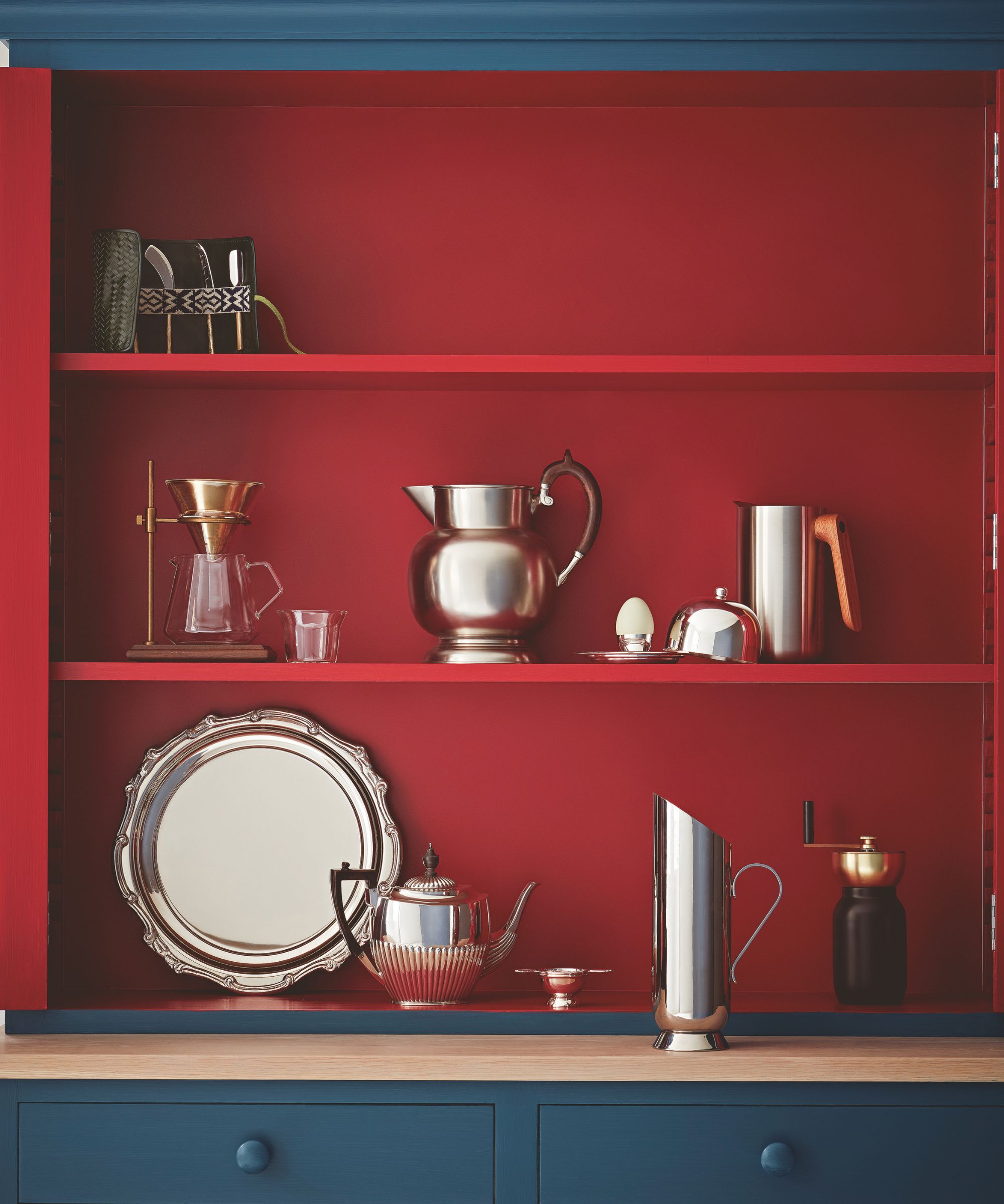 Blue cabinet with red shelves of silverware
