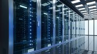 Data center server room with server racks in dark blue coloring.