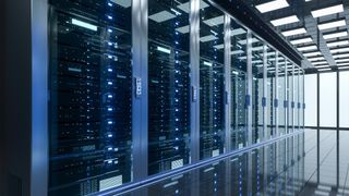 Data center server room with server racks in dark blue coloring.