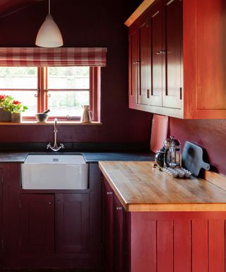 farrow & ball earthy red kitchen cabinets with gingham blind