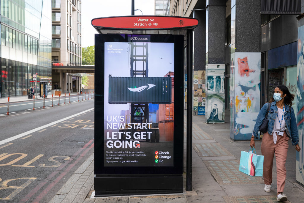 A pedestrian passes an advertisement from the U.K. government's &amp;quot;Let's Get Going&amp;quot; campaign