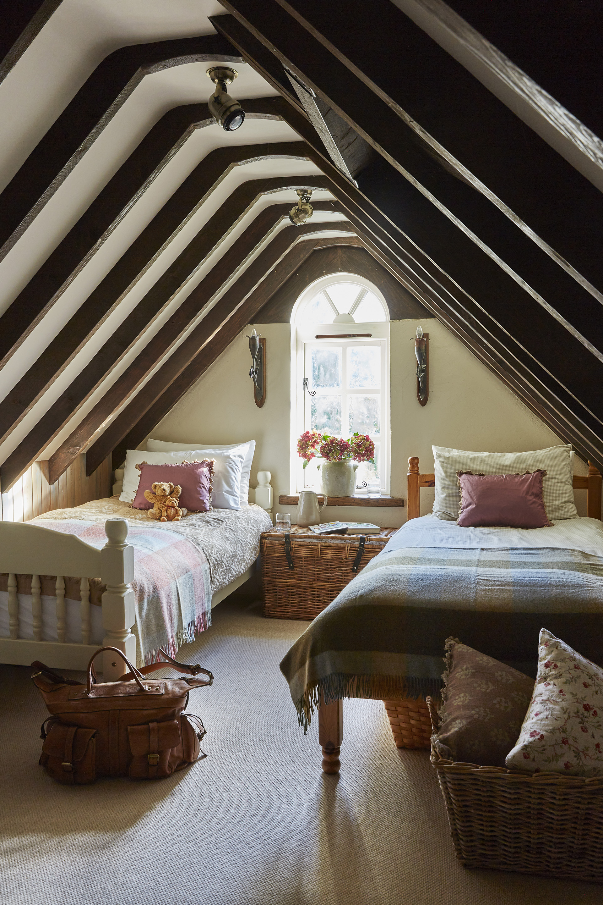 beamed attic bedroom in 17th century thatched cottage