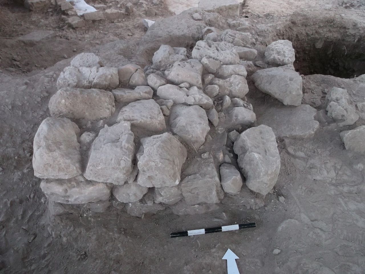 The altar and neighboring trash pit that contained ash and animal bones. These were located in the temple's courtyard.