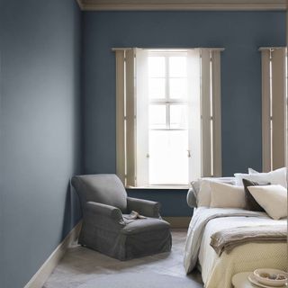 Denim Drift paint colour on bedroom walls with grey armchair