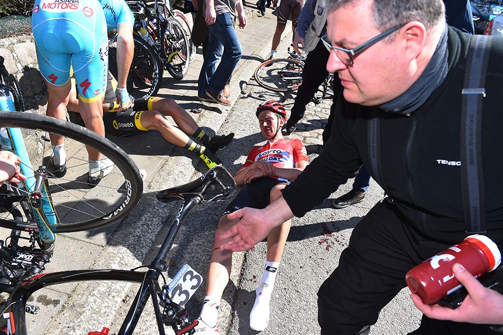 Lotto Soudal's Tiesj Benoot laying on the ground after crashing
