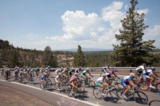 The elite men's peloton races through stunning Oregon scenery.