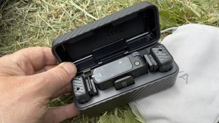 Shot of the plastic carry case with the lid opened to reveal two mics and a receiver