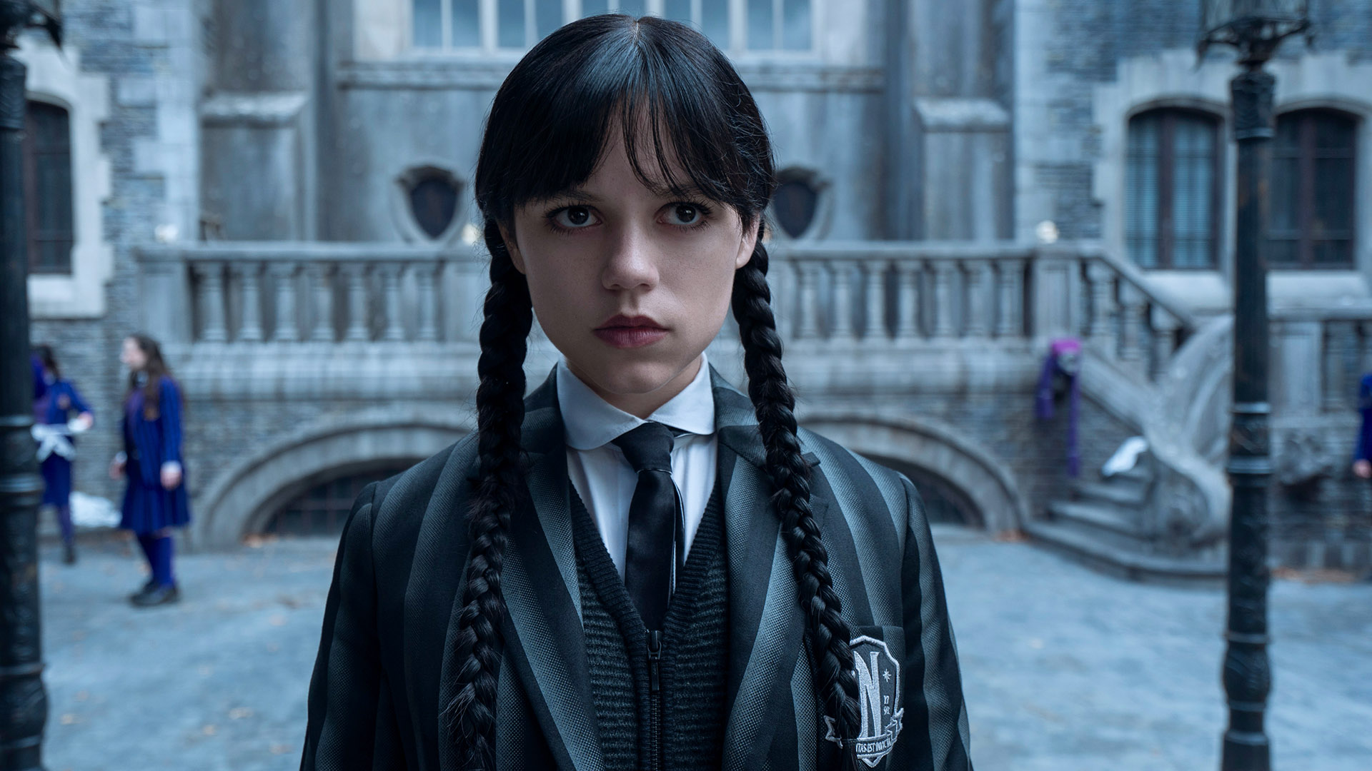 Jenna Ortega&#039;s Wednesday Addams standing in Nevermore Academy&#039;s courtyard in Wednesday season 2