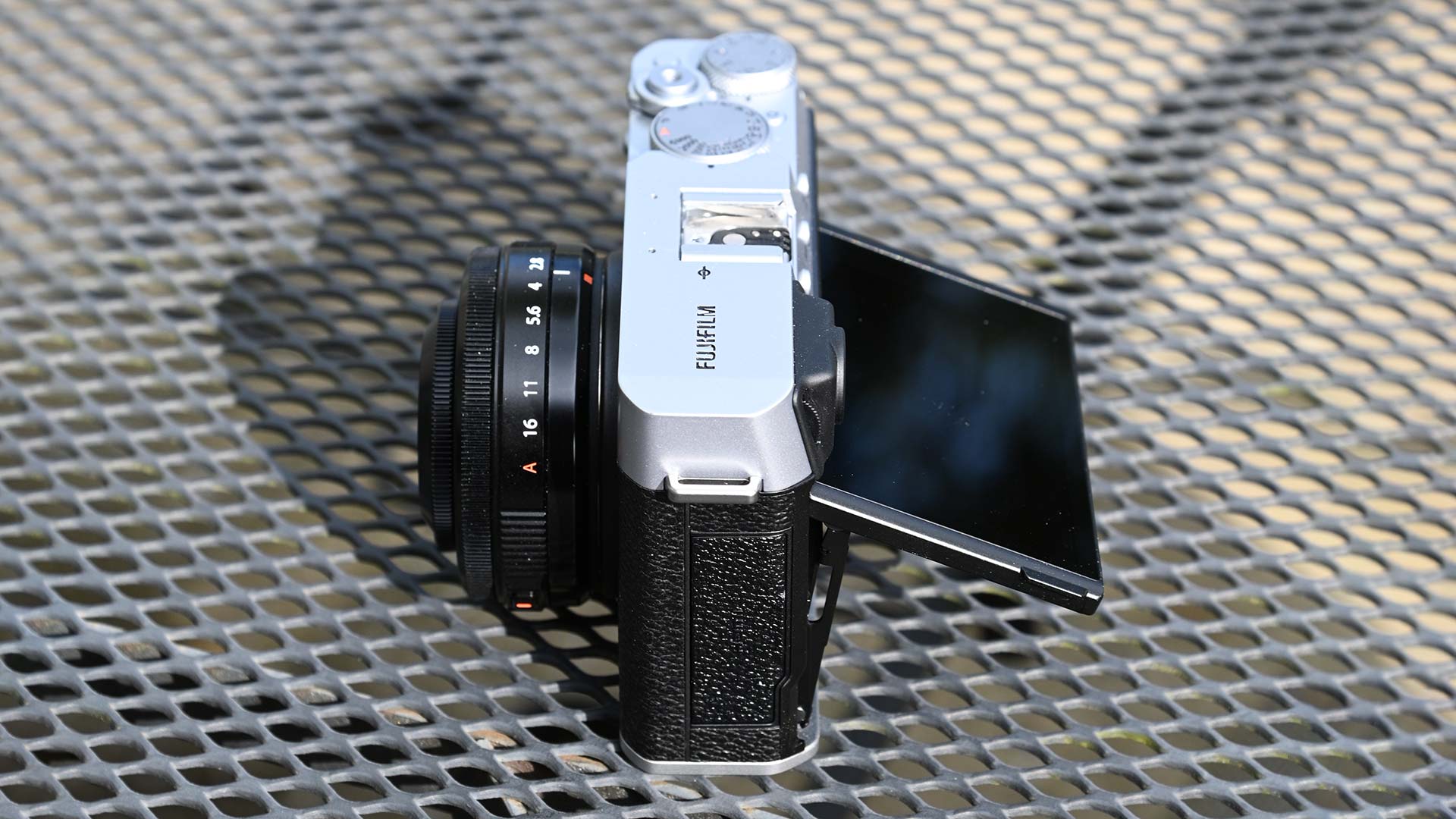 The Fujifilm X-E4 camera from above. The camera is resting on a wire mesh