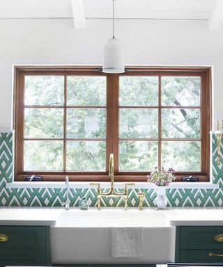 Interior designer Bobby Berk reveals his favorite green kitchen paints, dark green with brass taps