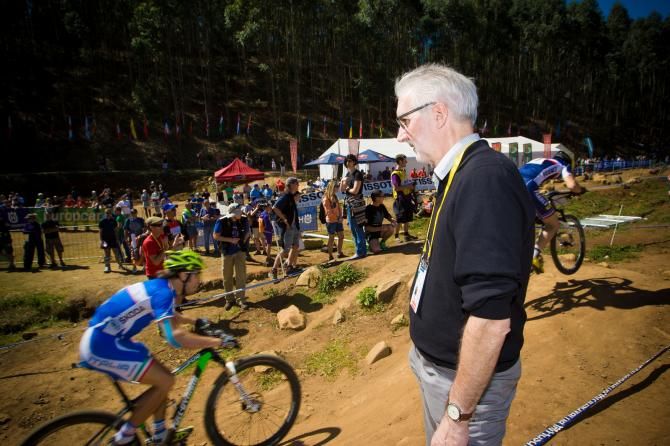 Brian Cookson watches racers pass by at the UCI Mountain Bike World Championships