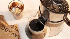 OXO Good Grips Cold Brew Coffee Maker viewed from above beside a glass of iced coffee