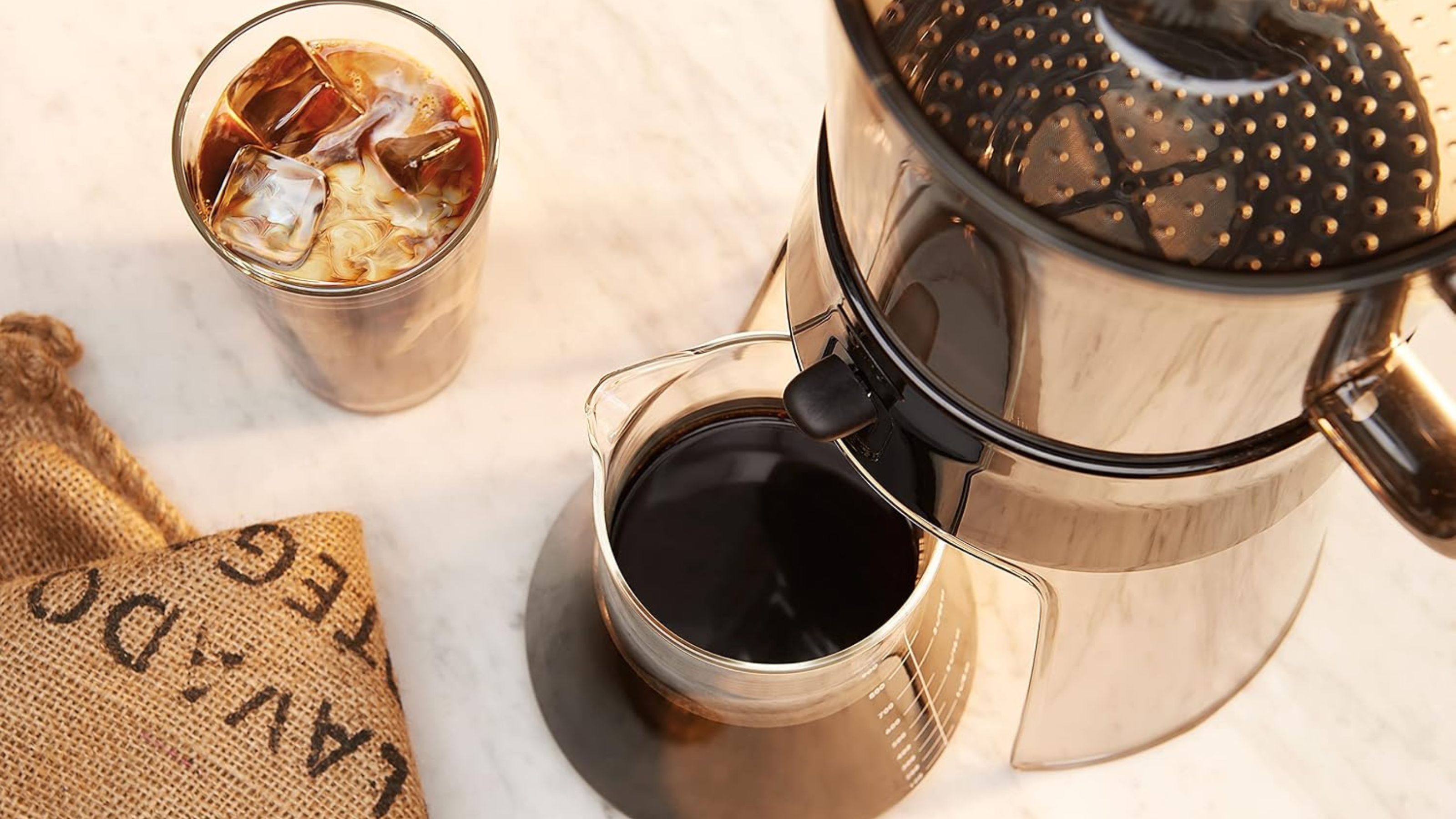 OXO Good Grips Cold Brew Coffee Maker viewed from above beside a glass of iced coffee