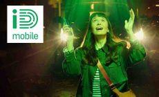 ID Mobile logo placed over an image of a woman very happy looking up at the sky with green light