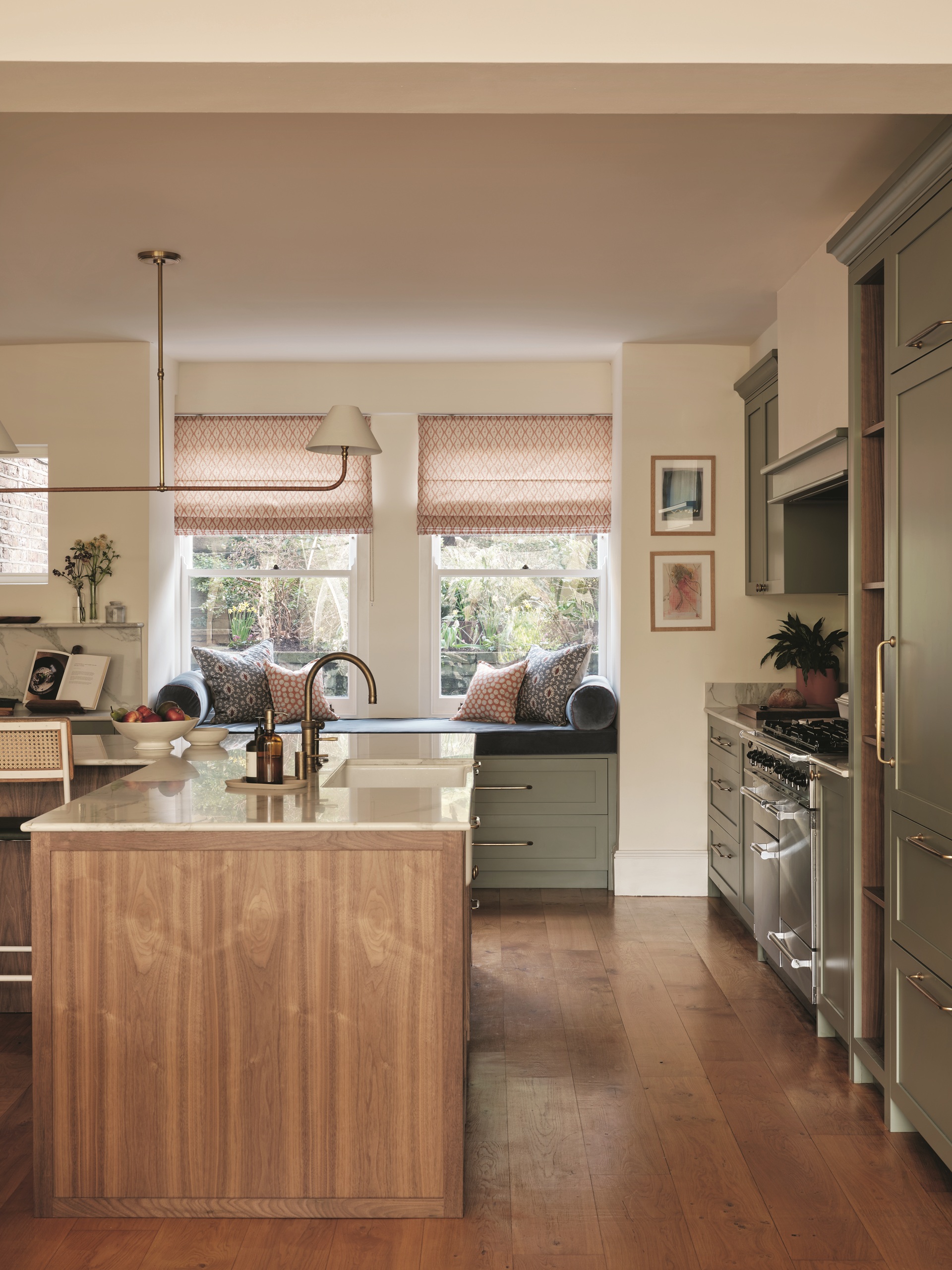 a kitchen with a wood island, green cabinets and a more traditional style