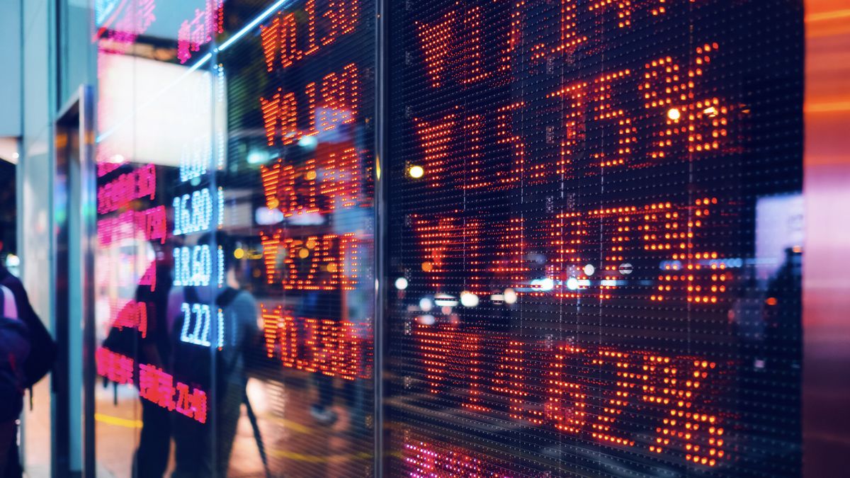 A display in public showing stocks and shares declining