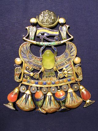This image shows Tutankhamun's brooch, which celebrates the ancient Egyptian pharaoh with a dazzling scarab made of yellow silica glass, which scientists say was likely formed from a comet impact millions of years ago.