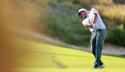 Emilio Gonzalez hits a wedge shot from the fairway