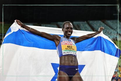 Lonah Chemtai Salpeter of Israel celebrates after the women's 10,000m at the European Championships with an Israeli flag