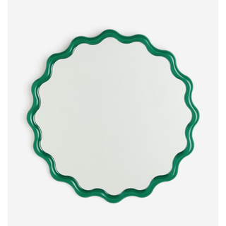 circular mirror with a green wavy border
