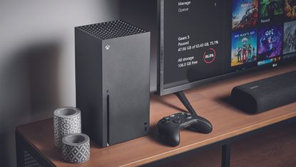 Xbox Series X console with controller next to 4K TV on wooden side table