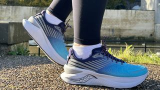 Woman's feet wearing Saucony Endorphin Shift 3 road running shoes - side view