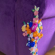 floral patch on purple velvet sofa