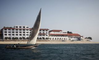 View of Park Hyatt hotel in Zanzibar with dhow in forefront