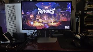 Samsung Odyssey G81SF gaming monitor resting on a desk with Marvel Rivals open
