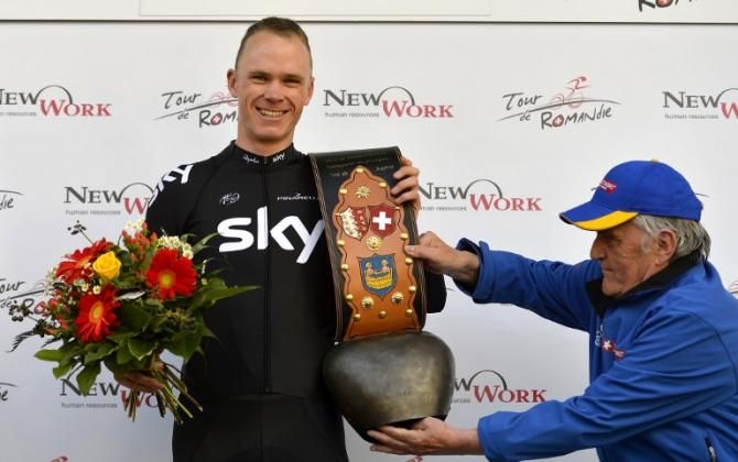 Chris Froome (Sky) gets some assistance at the prize giving ceremony