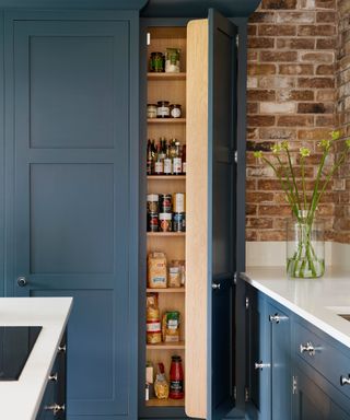 narrow larder unit in blue painted finish with a light wood interior