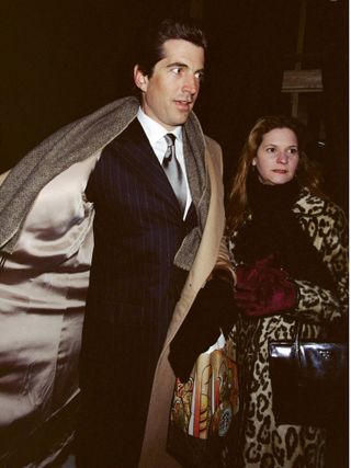 A photo of RoseMarie Terenzio wearing a leopard coat while out with John F. Kennedy Jr.