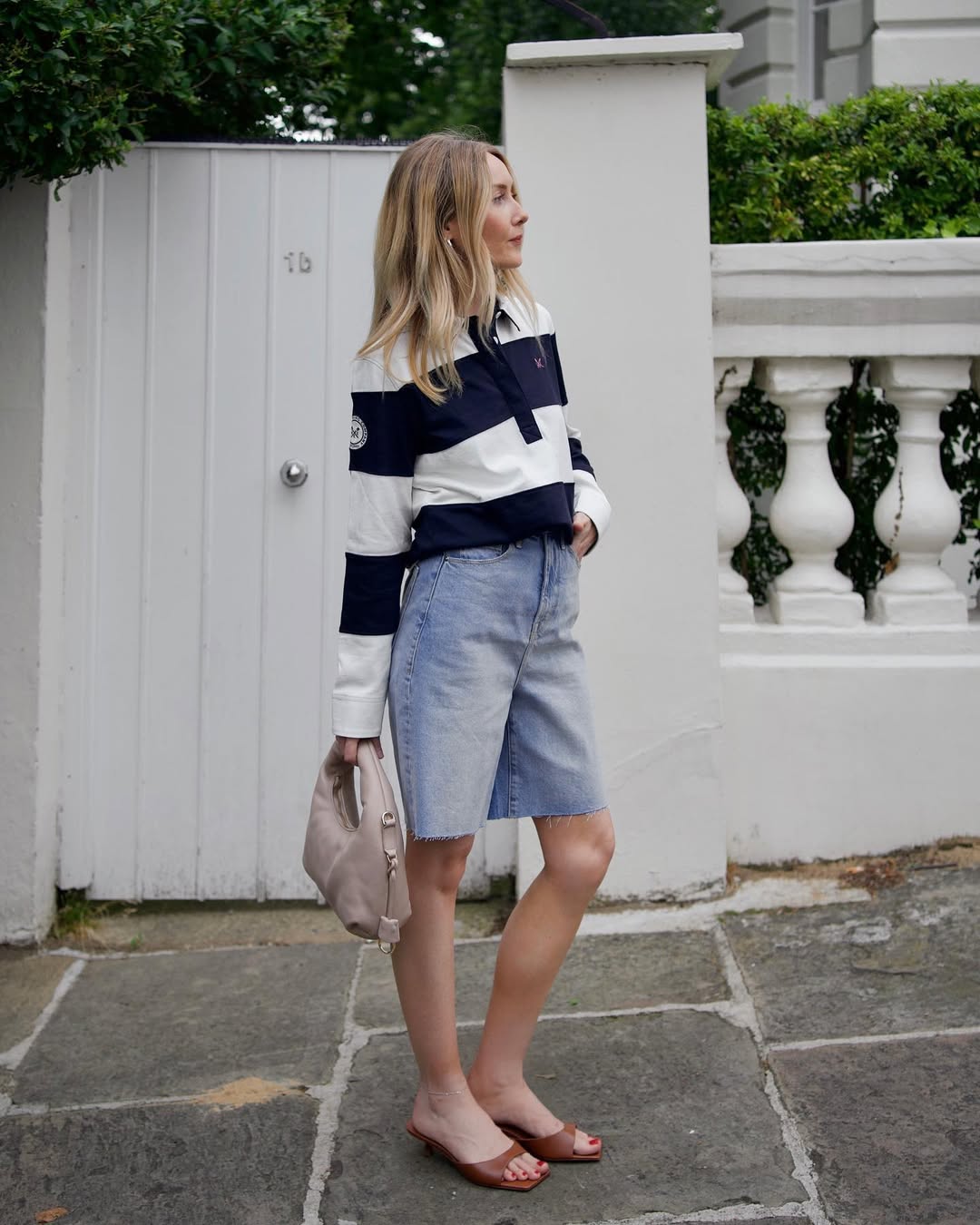 @chloekathbutler wears a rugby top, denim shorts and mules