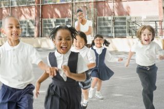 children running around in the playground - what to look out for when buying a school uniform