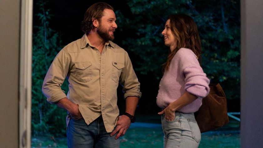 Max Thieriot as Bode looking at Alona Tal as Chloe in Fire Country. They&#039;re both smiling. 