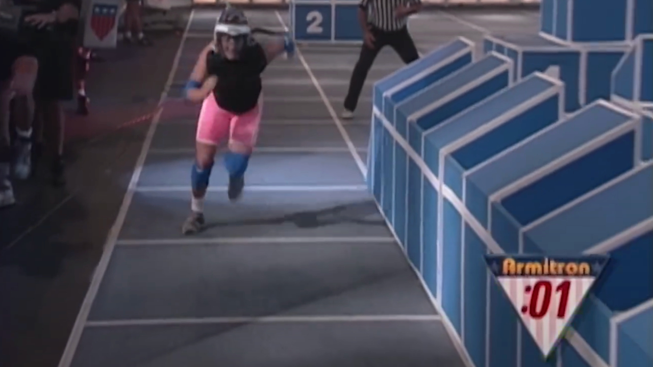 A contestant runs through the Assault course in American Gladiators S4 E22.