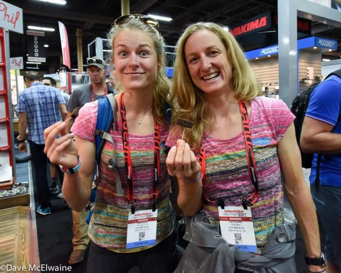 Luna team members Mags Rochette (L) and newly crowned world mountain biking champion (Catharine Pendrel) sample the new chocolate cupcake bar at the Cliff booth