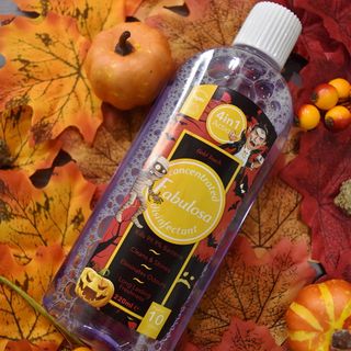 Fabulosa Gold touch disinfectant on top of autumn leaves next to 2 small pumpkins