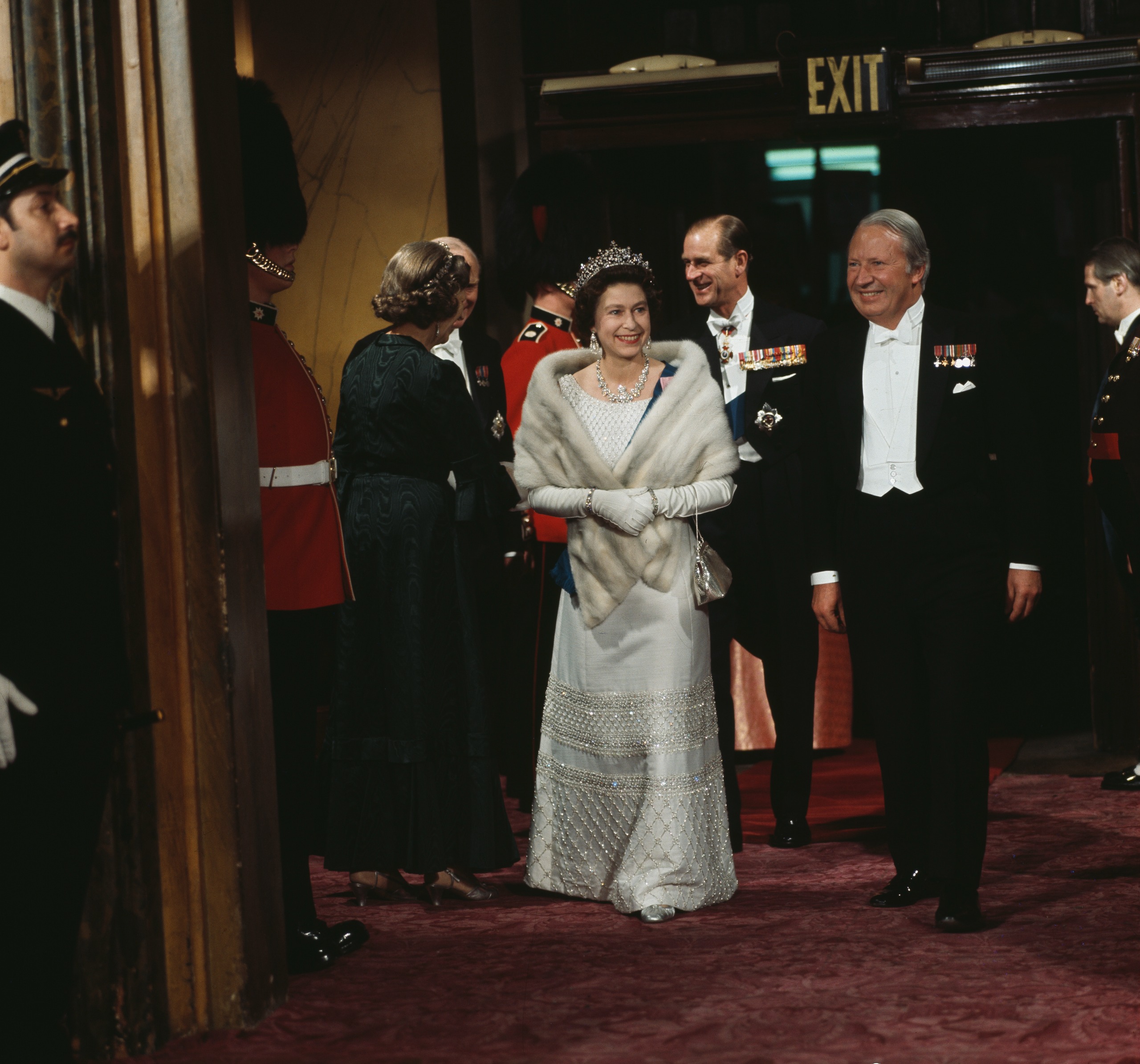 Queen Elizabeth wearing a fur stole and gown with a tiara