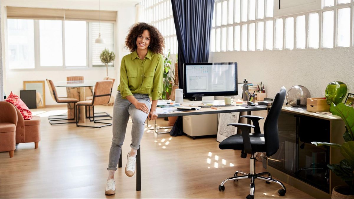 Woman at home sitting on work desk