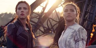 Natasha Romanoff/Black Widow (Scarlett Johansson) and Yelena Belova (Florence Pugh) look on in Black Widow (2021)