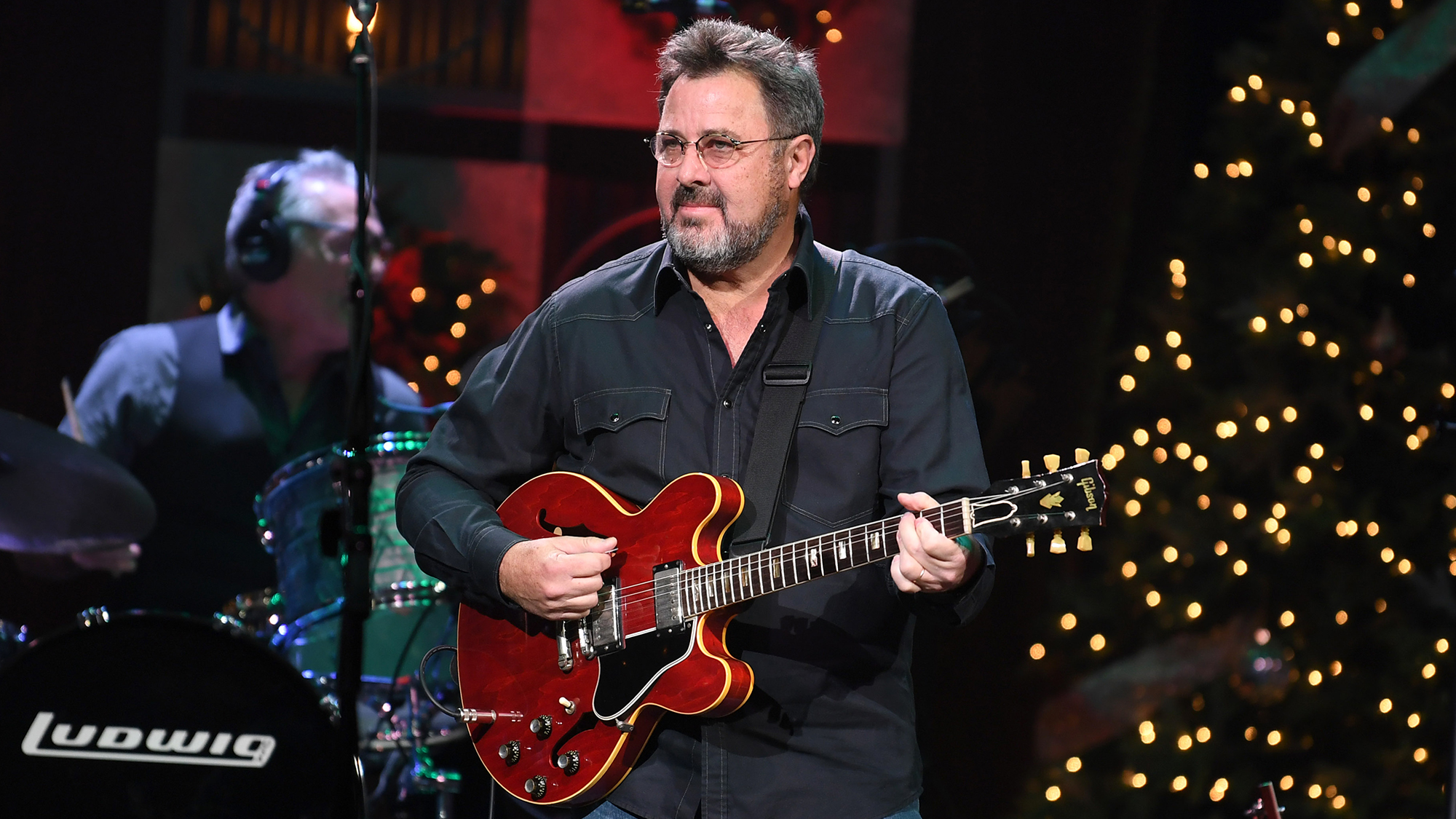 Vince Gill performs with his red Gibson ES-335 &amp;mdash;&amp;nbsp;his first guitar &amp;mdash;&amp;nbsp;during Christmas at The Ryman at the Ryman Auditorium on November 28, 2018 in Nashville, Tennessee.