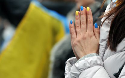 A woman with nails painted in the colors of the Ukrainian attends a mass rally of the opposition on Independence Square in Kiev on February 9, 2014. An estimated 70,000 pro-Western Ukrainians thronged the heart of Kiev on Sunday vowing never to give up their drive to oust President Viktor Yanukovych for his alliance with old master Russia. Wearing blue and yellow ribbons -- the colours of both Ukraine and the European Union -- the crowd sreceived a religious blessing before opposition leaders took to a podium on Independence Square in a bid to ratchet up pressure on Yanukovych to appoint a new pro-Western government