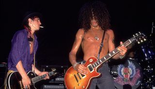 Izzy Stradlin (left) and Slash of Guns N' Roses perform at the Poplar Creek Music Theater in Hoffman Estates, Illinois on July 19, 1988