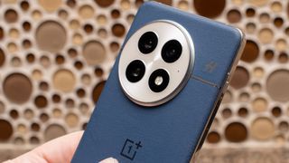 OnePlus 13 up close in blue showing cameras and H Hasselblad logo