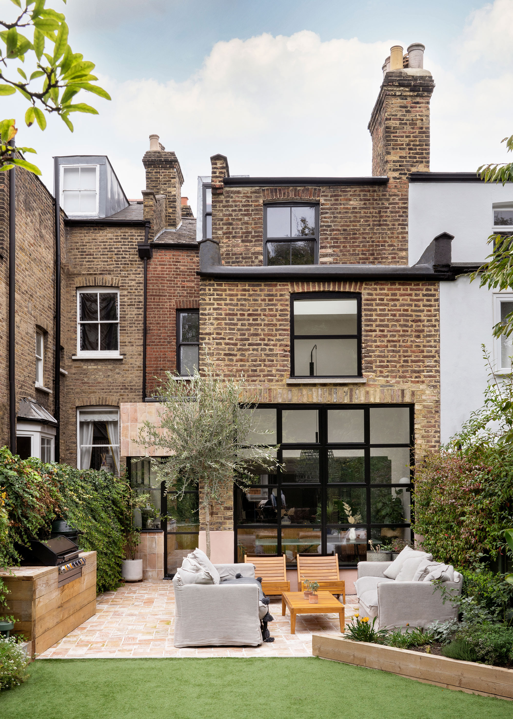 two-storey brick extension to London townhouse with black metal glazing